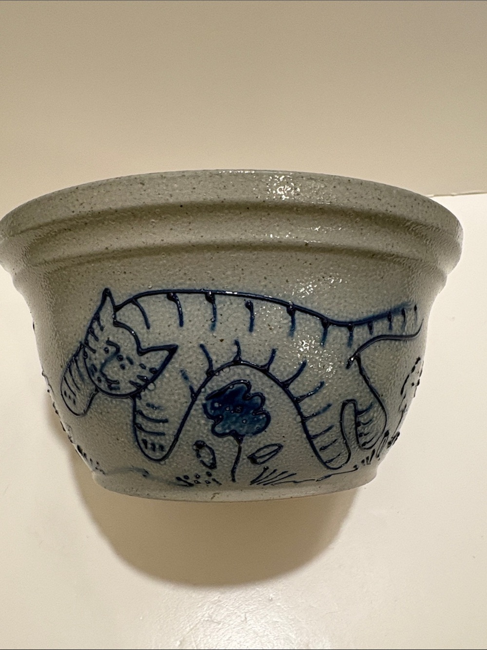 Eldreth Pottery bowl. Cat in blue, playing among flowers.  Made in 1995.